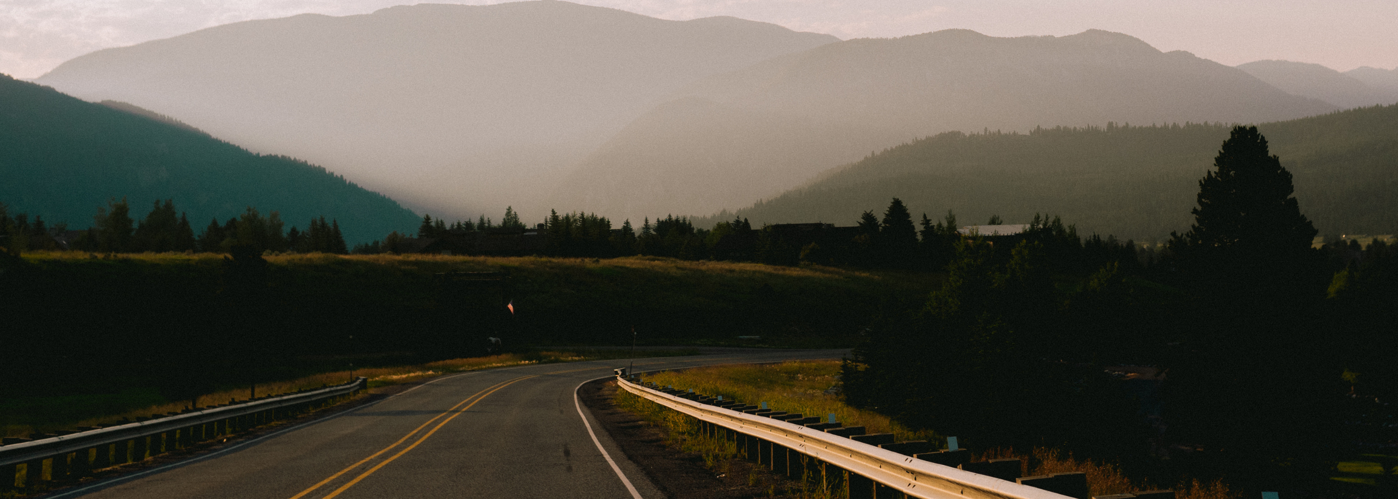 Landscape of road with mountains in the back.