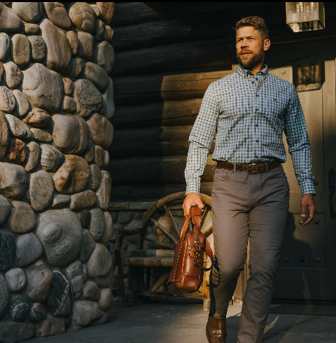 Man leaving a house with a briefcase in GenTeal clothing.