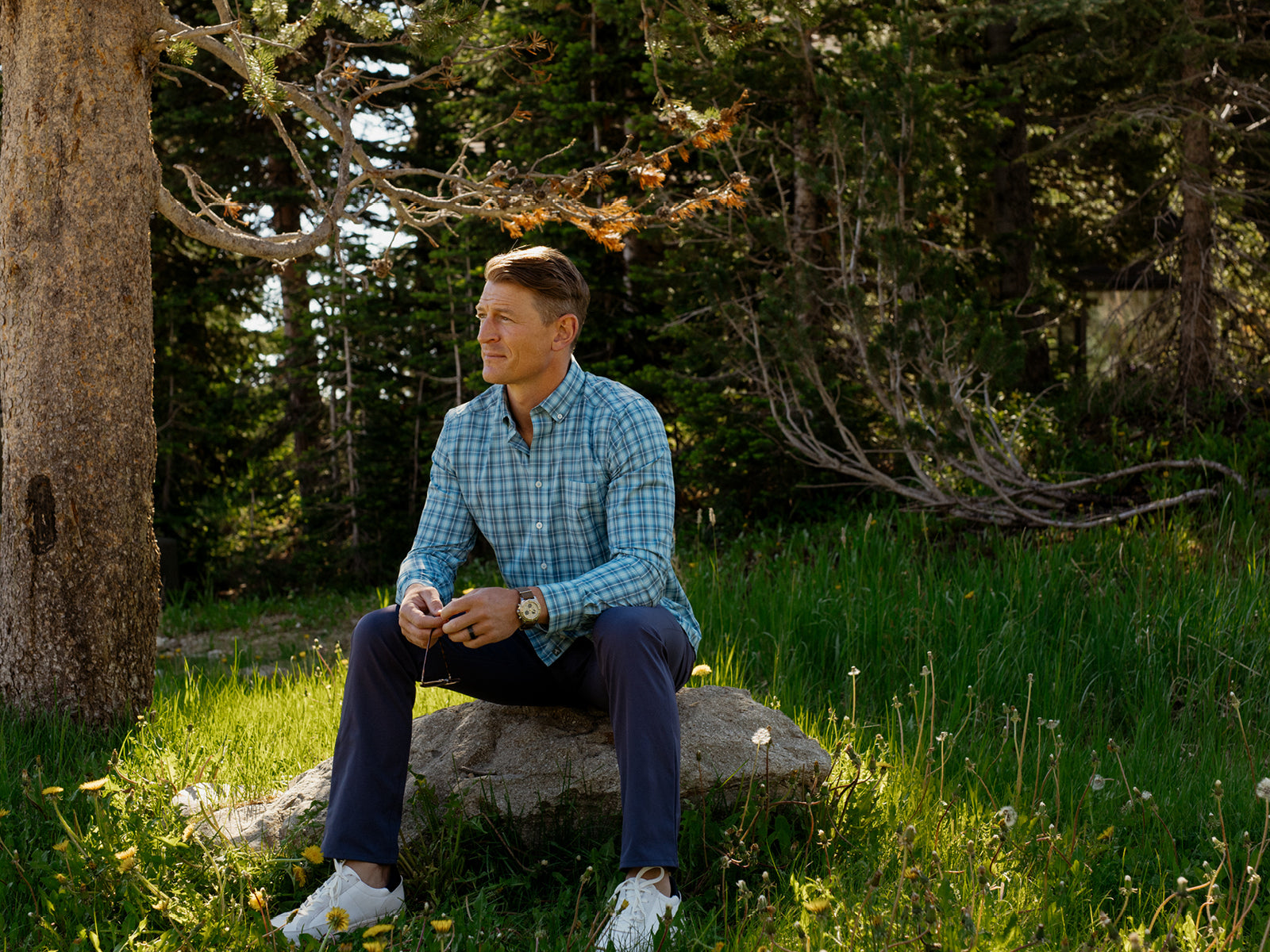 Man sitting outside on a rock in GenTeal mens clothing